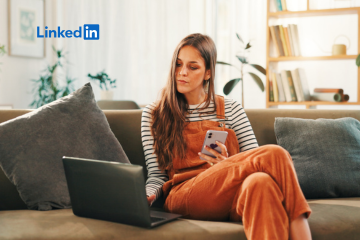 Photo of a lady sitting on a sofa with a laptop.