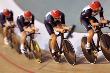 A photo showing 5x Team GB cyclists going around a velodrome.